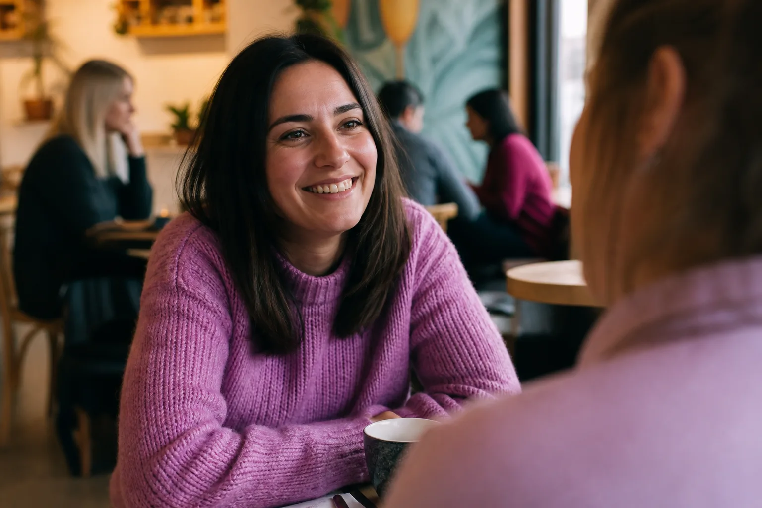 Two people talking over coffee at a café in St Helier, Jersey